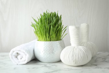 Spa composition with wheatgrass on white marble table