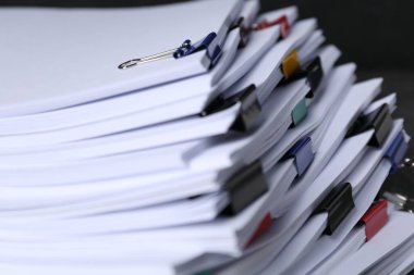 Siyah arkaplan üzerinde kağıt sayfaları olan renkli cilt klipleri, yakın plan