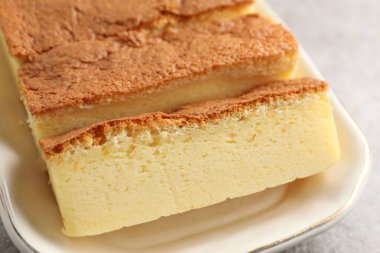 Tasty Japanese Castella sponge cake on light table, closeup