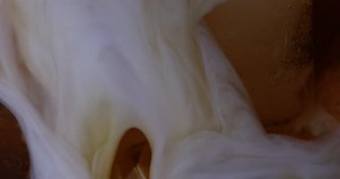 Arka plan olarak buzlu kahveye süt ekleniyor, yakın plan