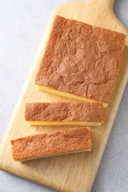 Tasty Japanese Castella sponge cake on light table, top view