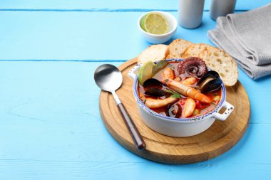 Lezzetli deniz ürünleri çorbası mavi ahşap masada, yakın plan. Metin için boşluk