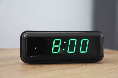 Dijital alarm saat 8 'de kapalı bir masada.