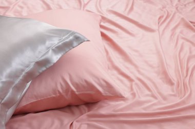 Yatakta güzel pembe ipek çarşaflar. Metin için boşluk