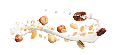 Yulaf gevreği, fındık ve beyaz arka planda havaya süt sıçratma. Pankart tasarımı