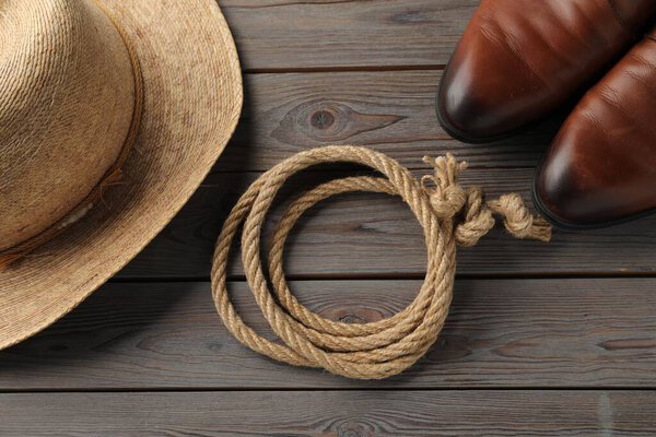 Cotton rope, straw hat and men shoes on wooden background, flat lay