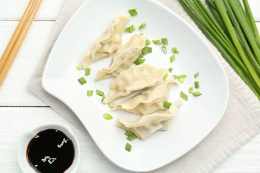 Lezzetli haşlanmış gyoza (hamur tatlısı) beyaz ahşap masada servis edilir.