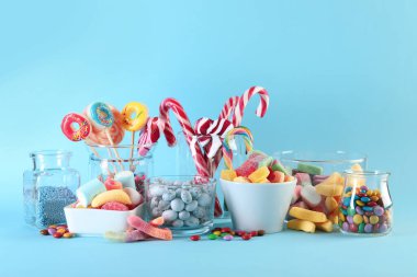 Candy bar. Many different sweets on light blue background. Space for text