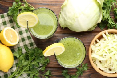 Sağlıklı maydanoz bardakta, limonda, lahanada, ahşap masada.