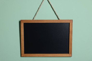 Turkuaz duvarda boş küçük bir karatahta