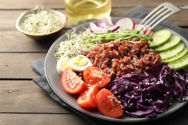 Tahta masada servis edilen kahverengi pirinçli lezzetli salata, yakın plan.