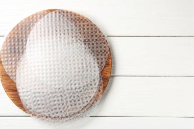 Beyaz ahşap masa üzerinde yenilebilir pirinç kağıtları, üst manzara. Metin için boşluk