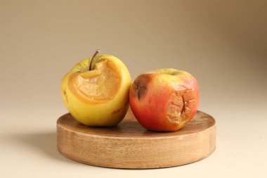 Bej arka planda iki çürük elma, yakın plan.