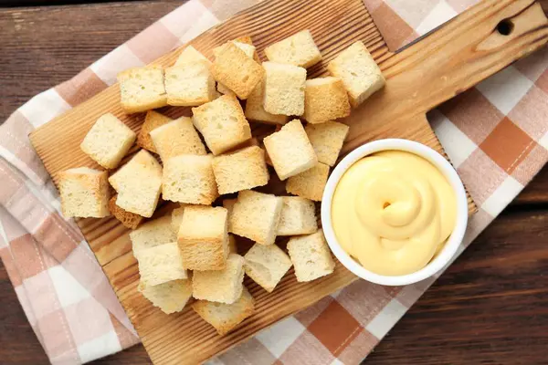 Ahşap masadaki soslu çıtır kıtır kızarmış ekmek.