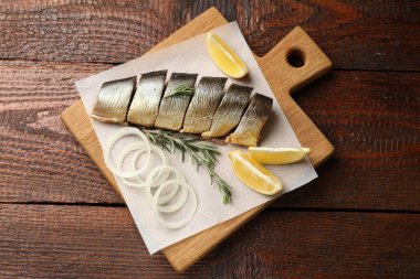 Tütsülenmiş ringa, soğan, biberiye ve limon ahşap masa, üst manzara