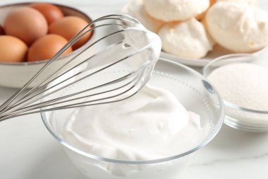 Krem şantili çırpma çırpma ve diğer malzemeler ışık masasında, yakın plan. Kurabiye pişiriyorum.