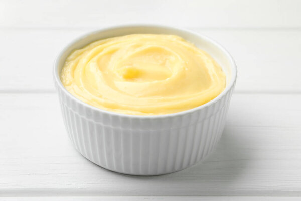 Вкусный ванильный пудинг на белом деревянном столе, крупным планом
