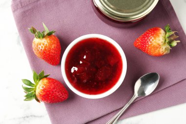Delicious strawberry sauce and fresh berries on white marble table, flat lay