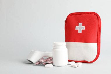 First aid kit. Different medical supplies on light grey background, space for text