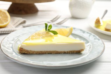 Beyaz ahşap masada limonlu peynirli kek, yakın plan.