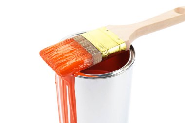 Can of orange paint and brush isolated on white