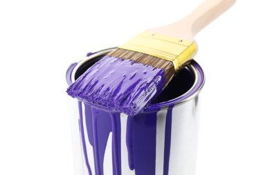 Can of violet paint and brush isolated on white