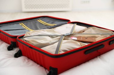 Paketleme küpleri ve pasaport biletleri bavulun içinde yatağın içinde, yakın plan.