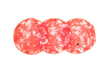 Slices of tasty smoked sausage on white background, top view