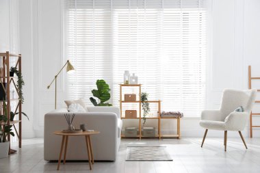 Odasında dekor ve kanepe olan şık raf ünitesi.