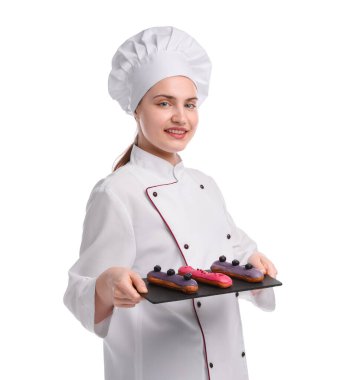 Üniformalı mutlu pastacı beyaz arka planda lezzetli ekinler tutuyor.