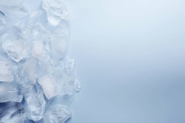 Açık mavi arka planda ezilmiş buz parçaları, üst manzara. Metin için boşluk