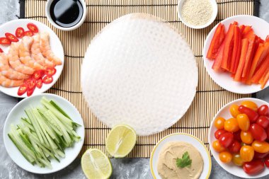 Pirinç kağıt çarşaflar ve açık gri masa üzerindeki farklı malzemeler, düz uzanmış.