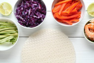 Pirinç kağıt çarşaflar ve beyaz ahşap masa üzerindeki farklı malzemeler.