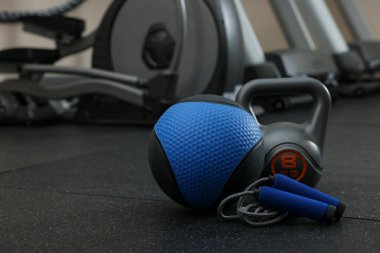 Mavi ilaç topu, kettlebell ve atlama halatı spor salonunda, mesaj atmak için yer