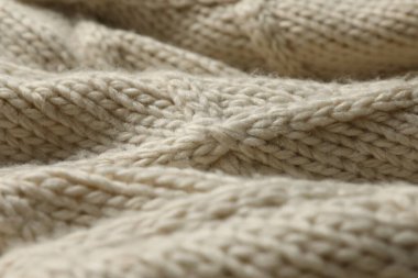 Arkaplan olarak bej örülmüş yün dokusu, yakın plan