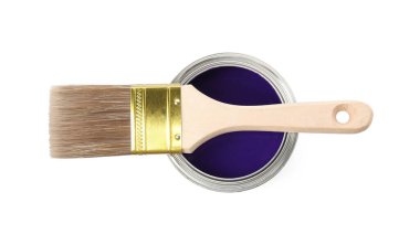 Can of purple paint and brush isolated on white, top view
