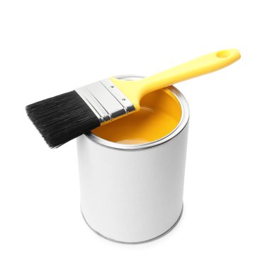 Can of yellow paint and brush isolated on white