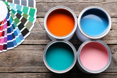 Parlak boya kutuları ve ahşap masa üzerinde renk paletleri, düz yatıyordu.