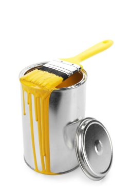 Can of yellow paint and brush isolated on white