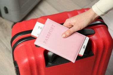 Pasaportu, bileti ve bavulu olan kadın, yakın plan.