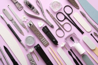 Pembe arka planda farklı manikür araçları, düz yatış