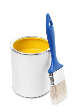 Can of yellow paint and brush isolated on white