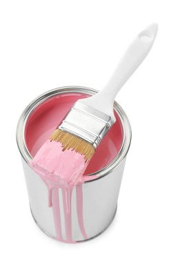 Can of pink paint and brush isolated on white
