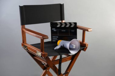 Klipperboard ve açık gri arka planda megafon ile yönetmen koltuğu.