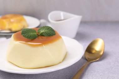Karamel soslu lezzetli puding ve nane şekeri, yakın plan.