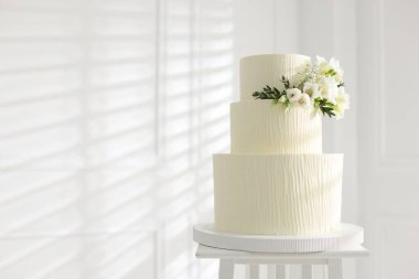 İçerideki masada çiçek desenli nefis düğün pastası, mesaj için yer var.