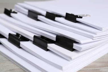 Masanın üzerinde kağıt kağıtları olan ataçlar, yakın plan