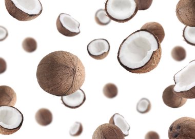 Beyaz arka planda uçan bir sürü taze hindistan cevizi.