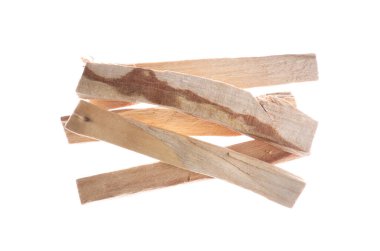 Pile of palo santo sticks in air on white background, top view