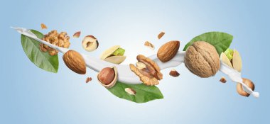 Açık mavi arka planda farklı fındıklı süt sıçraması